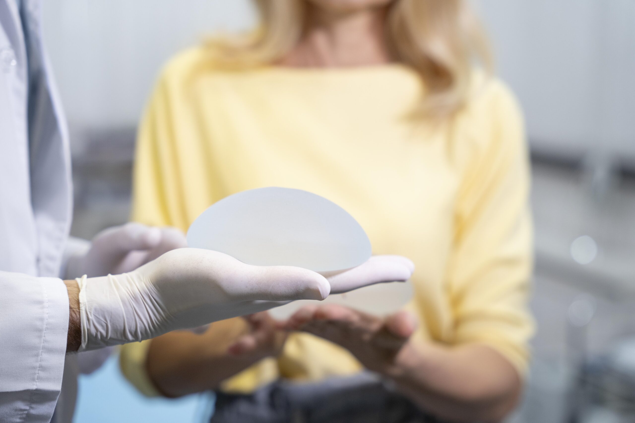Servicios close up hands holding breast implant